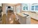 Open kitchen layout with a breakfast bar and granite countertops, seamlessly flowing into the living spaces at 1620 Silverleaf Way, Alpharetta, GA 30005