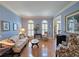 Inviting living room with hardwood floors, crown molding, and large windows providing natural light and bright atmosphere at 1620 Silverleaf Way, Alpharetta, GA 30005