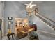 Two-story living room boasts a fireplace, a staircase and seamless flow to the kitchen at 1620 Silverleaf Way, Alpharetta, GA 30005
