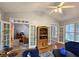 Bright living room featuring hardwood floors, french doors, neutral walls, and modern ceiling fan at 1620 Silverleaf Way, Alpharetta, GA 30005