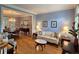 Open-concept living and dining areas with hardwood floors, large windows, and traditional decor for entertaining at 1620 Silverleaf Way, Alpharetta, GA 30005