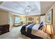 Main bedroom featuring a tray ceiling, sitting area, and plush carpet at 1620 Silverleaf Way, Alpharetta, GA 30005