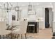 Elegant kitchen featuring a black island, modern lighting, and an adjacent dining area at 2718 Byess Ct, Marietta, GA 30064