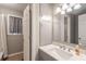 Bathroom featuring white cabinets, modern lighting, and marble countertops at 409 Colette Ln, Social Circle, GA 30025