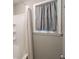Bright bathroom featuring a shower with window and curtain at 409 Colette Ln, Social Circle, GA 30025