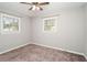 Bedroom featuring two windows, neutral colors, and carpet at 409 Colette Ln, Social Circle, GA 30025