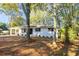 Front elevation of home with brick and a covered parking area at 409 Colette Ln, Social Circle, GA 30025
