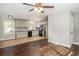 Open concept kitchen with stainless steel appliances, gray cabinets, and hardwood flooring at 409 Colette Ln, Social Circle, GA 30025