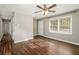 Open living room with hardwood flooring, a ceiling fan, and access to nearby rooms at 409 Colette Ln, Social Circle, GA 30025