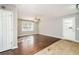 A cozy living room features hardwood floors, a fan, and light gray walls, creating an inviting atmosphere at 409 Colette Ln, Social Circle, GA 30025