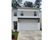 Two-story home with white garage door, neutral siding, and black front door at 4856 Station Road-Lot 21, Union City, GA 30349
