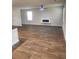 Open living room with luxury vinyl flooring, recessed lights, and modern electric fireplace at 4856 Station Road-Lot 21, Union City, GA 30349