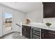 Home bar area featuring a wine fridge, sink, and access to an outdoor patio at 1049 Brandsford Nw St # 27-01, Atlanta, GA 30318