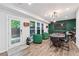 Finished basement with stylish green accent wall, ample seating, and walk-out access to backyard at 1049 Brandsford Nw St # 27-01, Atlanta, GA 30318