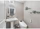 Elegant powder room featuring a pedestal sink, modern fixtures, and decorative wallpaper at 1049 Brandsford Nw St # 27-01, Atlanta, GA 30318