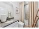 Cozy bathroom with modern fixtures, neutral tile surround, and decorative ladder accent at 1049 Brandsford Nw St # 27-01, Atlanta, GA 30318