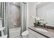 Modern bathroom featuring a bathtub with shower and a stylish sink with white orchid at 1049 Brandsford Nw St # 27-01, Atlanta, GA 30318