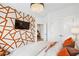 Modern bedroom featuring geometric accent wall, stylish chandelier, and comfortable furnishings at 1049 Brandsford Nw St # 27-01, Atlanta, GA 30318