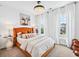 Bright bedroom features a bed with an orange headboard, large windows, and unique decor at 1049 Brandsford Nw St # 27-01, Atlanta, GA 30318