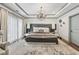 Luxurious main bedroom with tray ceilings, chandelier lighting, and modern accents at 1049 Brandsford Nw St # 27-01, Atlanta, GA 30318