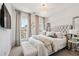 Bright main bedroom with tufted headboard, decorative pillows, and designer lighting at 1049 Brandsford Nw St # 27-01, Atlanta, GA 30318