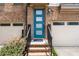 Welcoming front entry featuring a stylish blue door and well-manicured landscaping with an attached garage at 1049 Brandsford Nw St # 27-01, Atlanta, GA 30318
