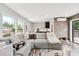 Inviting living room area with large windows, modern decor, and access to an outdoor patio at 1049 Brandsford Nw St # 27-01, Atlanta, GA 30318