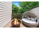 Inviting patio with a modern wicker couch and fire pit, perfect for cozy outdoor relaxation at 1049 Brandsford Nw St # 27-01, Atlanta, GA 30318