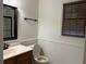 Cozy bathroom with oak vanity, updated fixtures, and wood blinds at 2181 Rodao Sw Dr, Lilburn, GA 30047