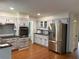 Bright kitchen with stainless steel appliances, white cabinets, granite counters, and subway tile backsplash at 2181 Rodao Sw Dr, Lilburn, GA 30047