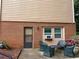 Cozy brick patio with outdoor seating area and flowering plants at 2181 Rodao Sw Dr, Lilburn, GA 30047