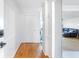 Bright hallway featuring paneled walls and hardwood flooring, leading to other rooms at 2965 Pharr Court South Nw # 817, Atlanta, GA 30305