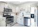 Modern kitchen with white cabinets, stainless steel appliances, and white countertops at 2965 Pharr Court South Nw # 817, Atlanta, GA 30305