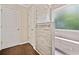 Tiled shower with a bench and a glass partition and a white door at 405 Maple Rdg, White, GA 30184