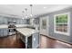 Charming kitchen with gray cabinets, granite counters, stainless appliances, and a central island at 405 Maple Rdg, White, GA 30184