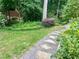 Landscaped backyard featuring stone path and mature shade trees at 1884 Whitehawk Ct, Lawrenceville, GA 30043