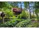 Serene backyard view featuring a deck and lush landscaping at 1884 Whitehawk Ct, Lawrenceville, GA 30043