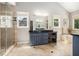 Bright bathroom featuring a spacious vanity, soaking tub, and glass-enclosed shower at 1884 Whitehawk Ct, Lawrenceville, GA 30043