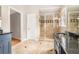 Bathroom featuring double vanity with granite countertop and a large glass-enclosed shower at 1884 Whitehawk Ct, Lawrenceville, GA 30043