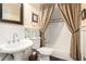 Charming bathroom with pedestal sink and tub/shower combo with decorative shower curtain at 1884 Whitehawk Ct, Lawrenceville, GA 30043