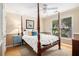 Bedroom featuring a four-poster bed, hardwood floors and plenty of natural light at 1884 Whitehawk Ct, Lawrenceville, GA 30043