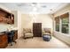 Cozy bedroom featuring a built in desk and chair, seating, and a neutral color palette at 1884 Whitehawk Ct, Lawrenceville, GA 30043