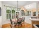 Charming dining area with a wooden table, decorative lighting, and bright natural light at 1884 Whitehawk Ct, Lawrenceville, GA 30043