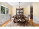 Bright dining area featuring yellow walls, hardwood floors, and a large window with shutters at 1884 Whitehawk Ct, Lawrenceville, GA 30043