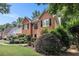 Beautiful brick home with lush landscaping and a well-maintained lawn on a sunny day at 1884 Whitehawk Ct, Lawrenceville, GA 30043