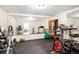 Well-equipped home gym with rubber flooring and mirrored wall at 1884 Whitehawk Ct, Lawrenceville, GA 30043