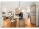 Bright, open kitchen with hardwood floors, an island with seating, and stainless steel appliances at 1884 Whitehawk Ct, Lawrenceville, GA 30043