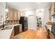 Well-lit kitchen featuring stainless steel appliances, a breakfast bar, and hardwood floors at 1884 Whitehawk Ct, Lawrenceville, GA 30043