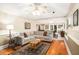 Spacious living room featuring a large sectional sofa, hardwood floors, and recessed lighting at 1884 Whitehawk Ct, Lawrenceville, GA 30043