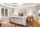 Serene main bedroom featuring a tray ceiling, large windows, and neutral decor at 1884 Whitehawk Ct, Lawrenceville, GA 30043